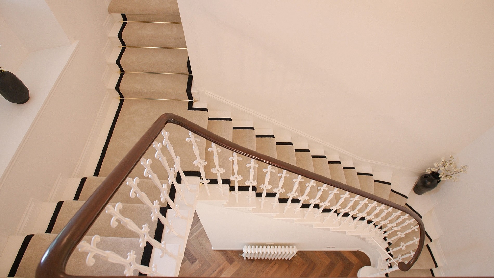 Stairs and hallway with pale carpet 